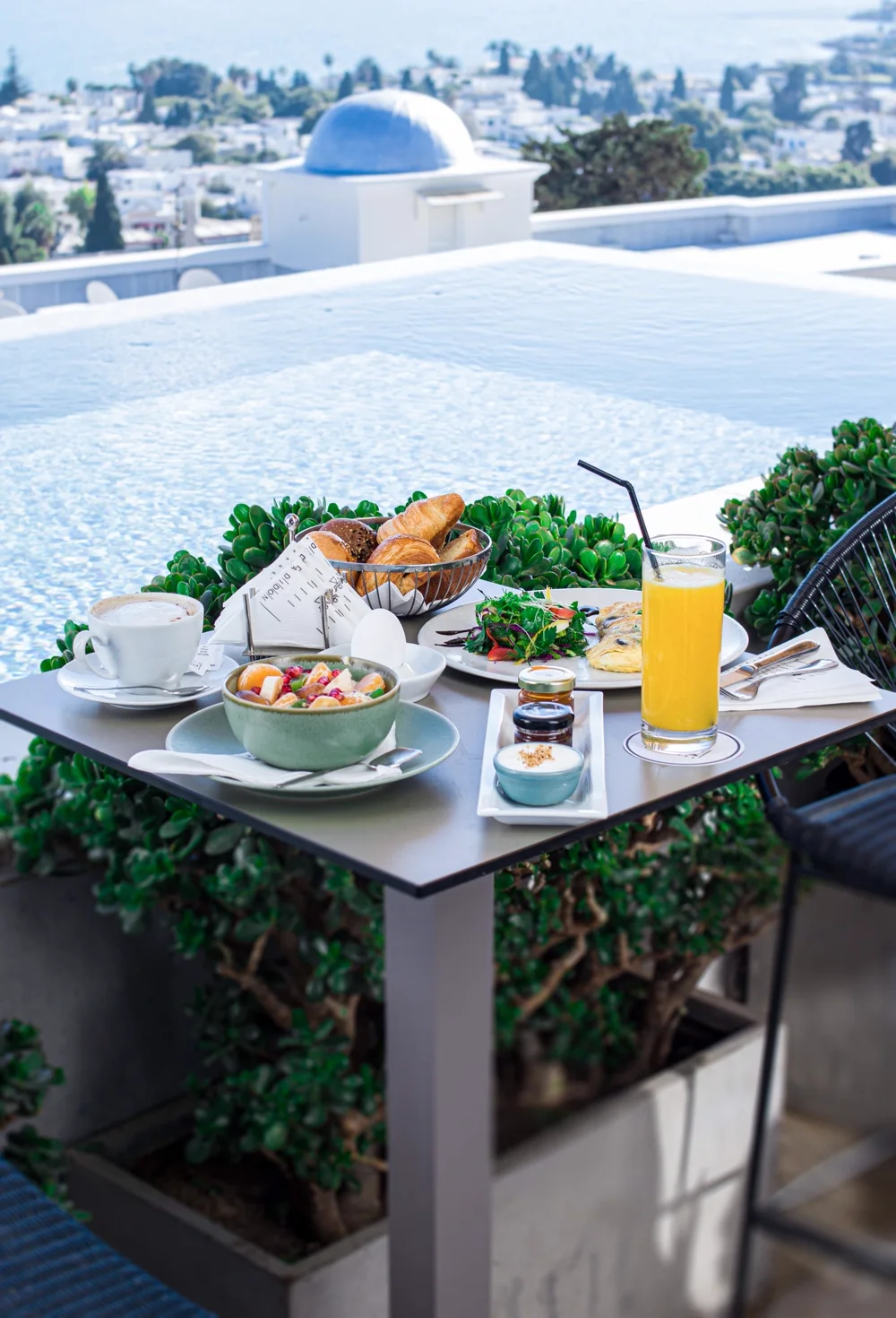 The breakfast tray above the white roofs and domes of Carthage