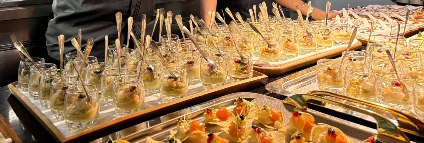 Verrines and canapés for the drinks reception, lined up on trays in the kitchen