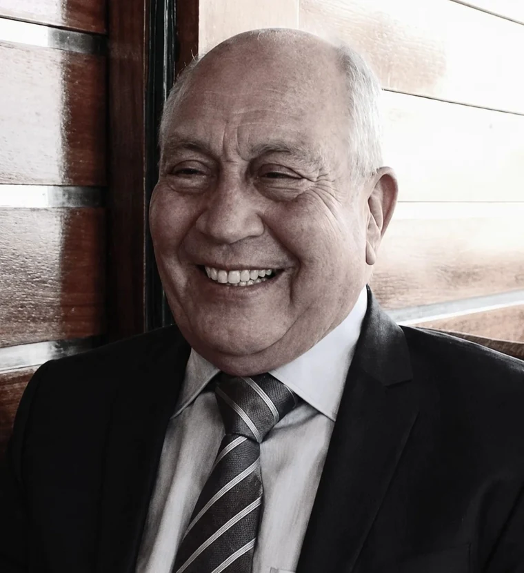 Portrait of Mongi Loukil, smiling, in a suit and tie